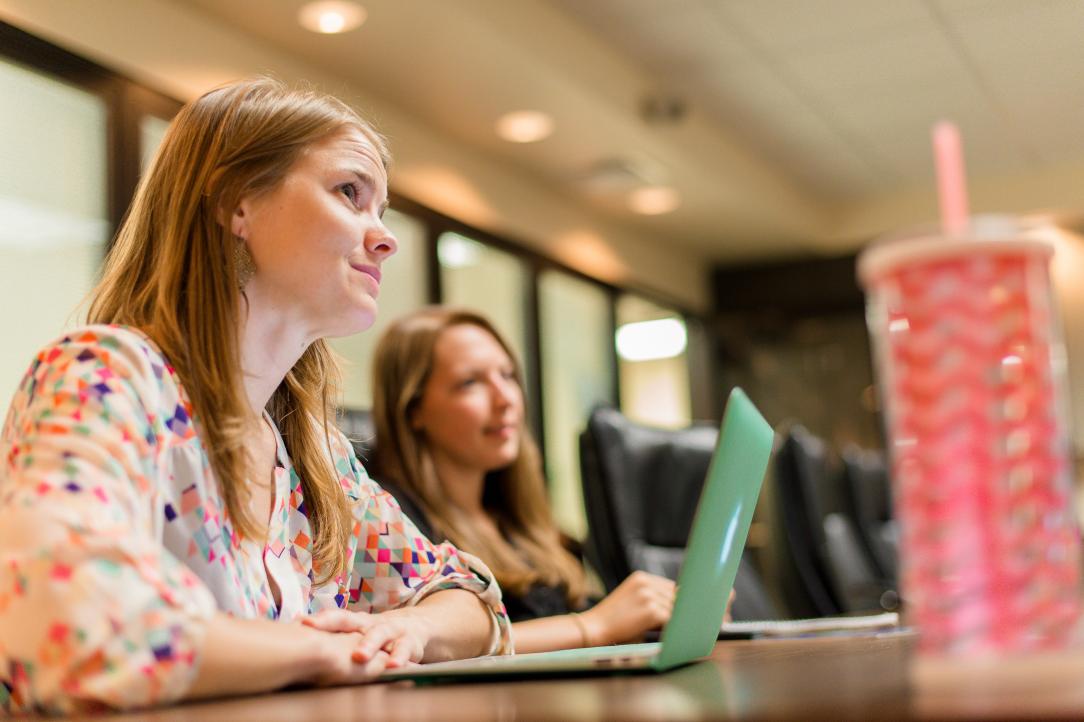 two female marketing professionals meeting in conference room